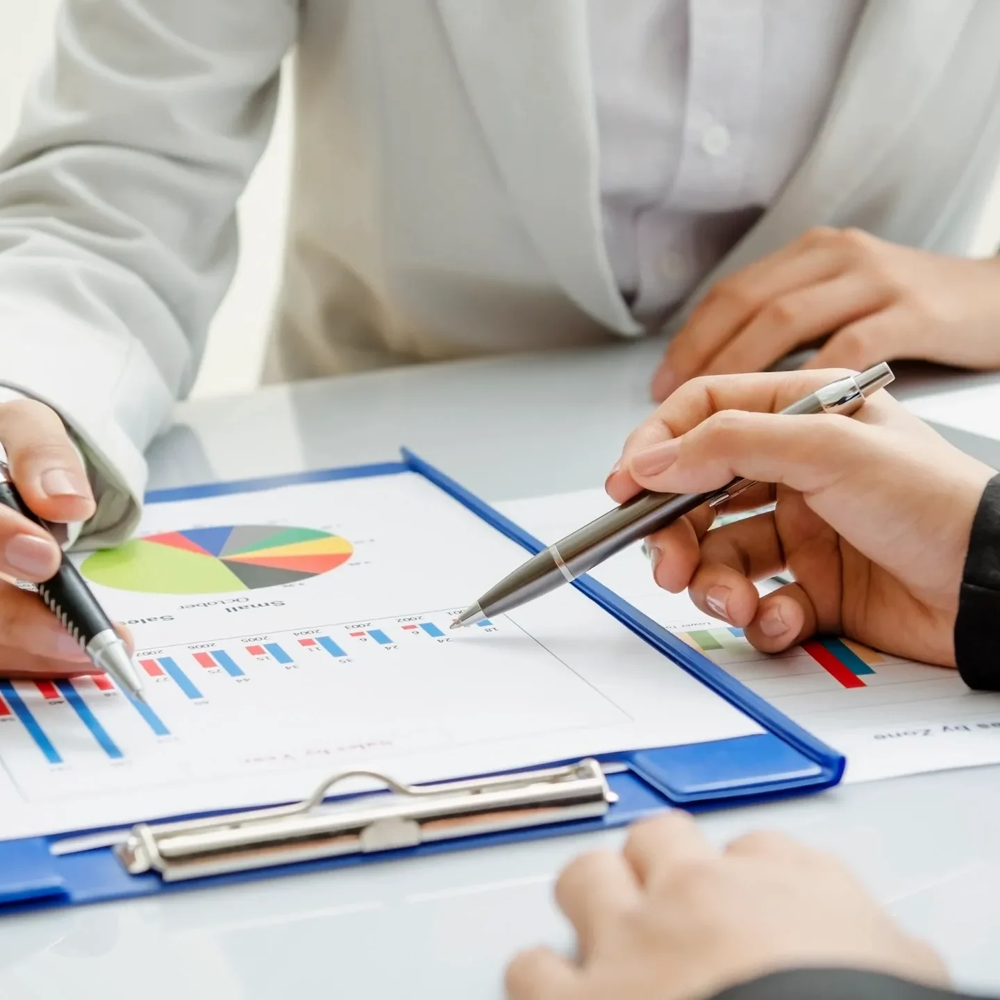 Business professionals discussing financial charts and reports.