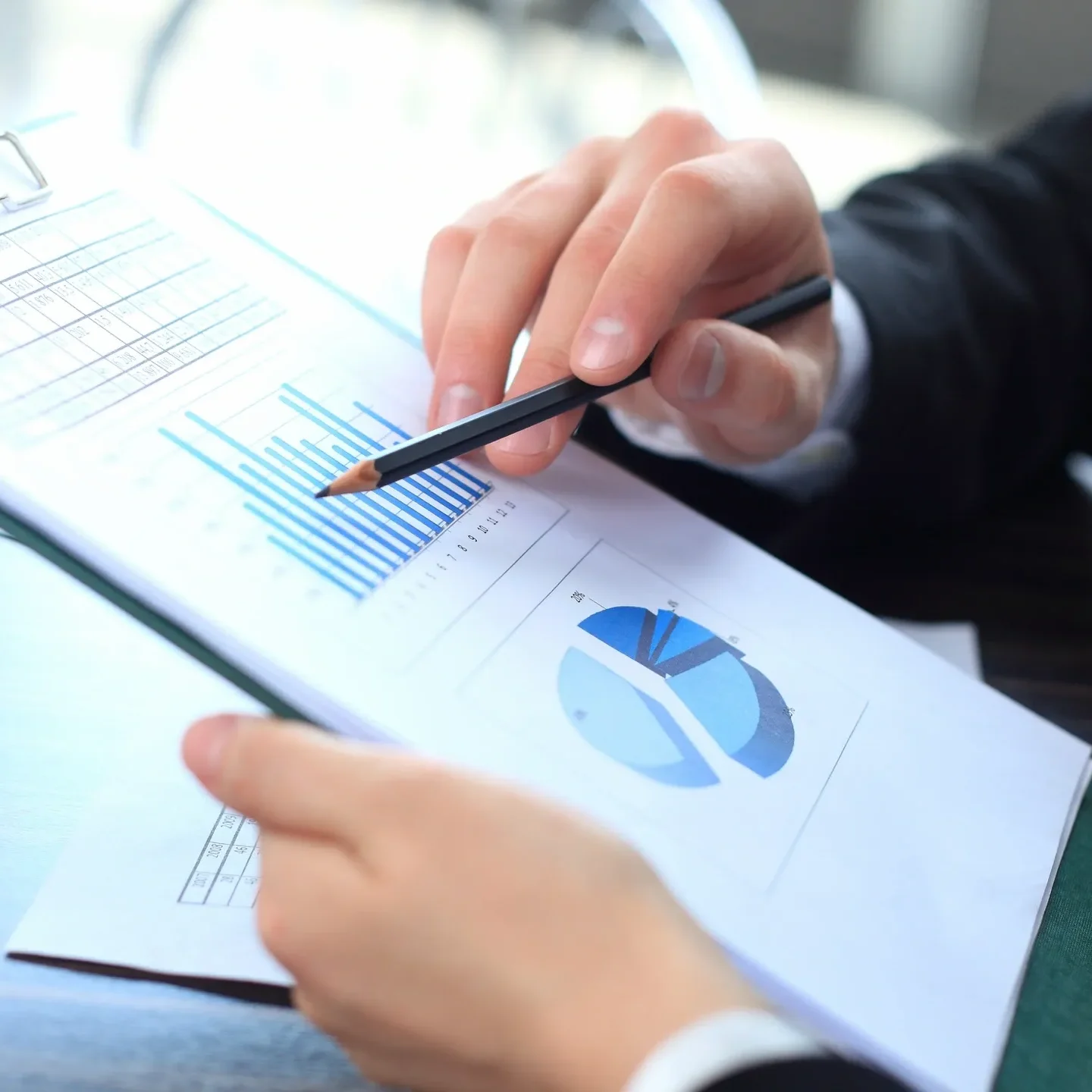 Two professionals analyzing financial charts and data together.